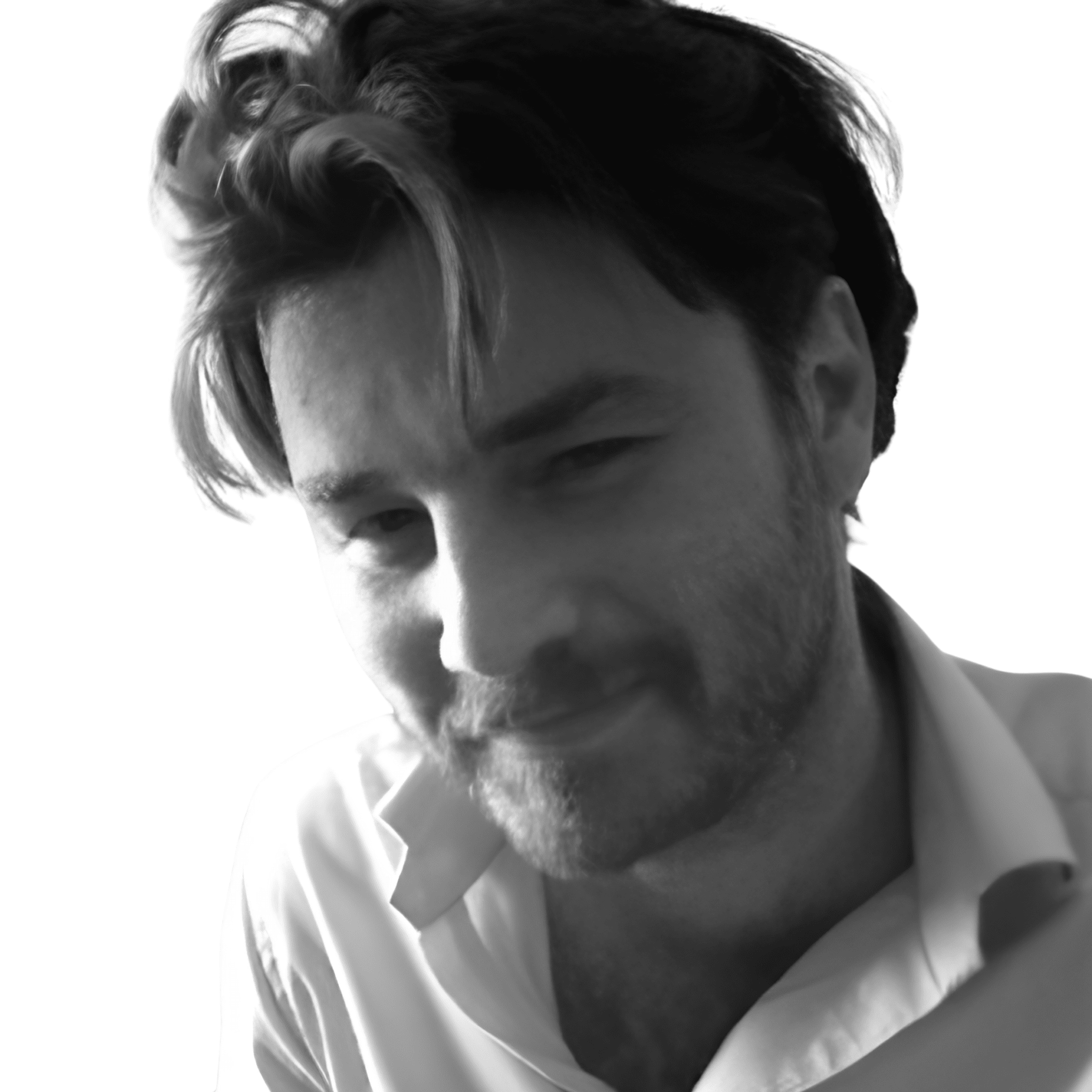 A headshot of Ed Ward in black and white