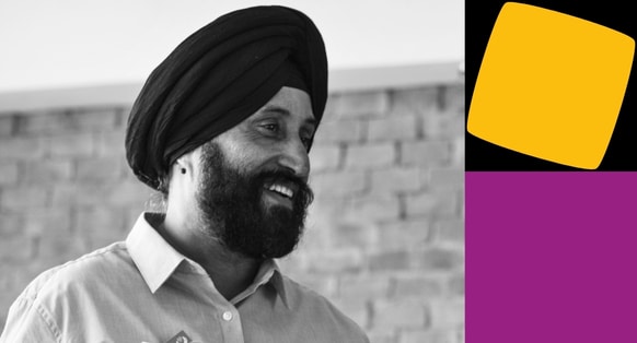 A man smiling into the distance with Yellow and Purple shapes