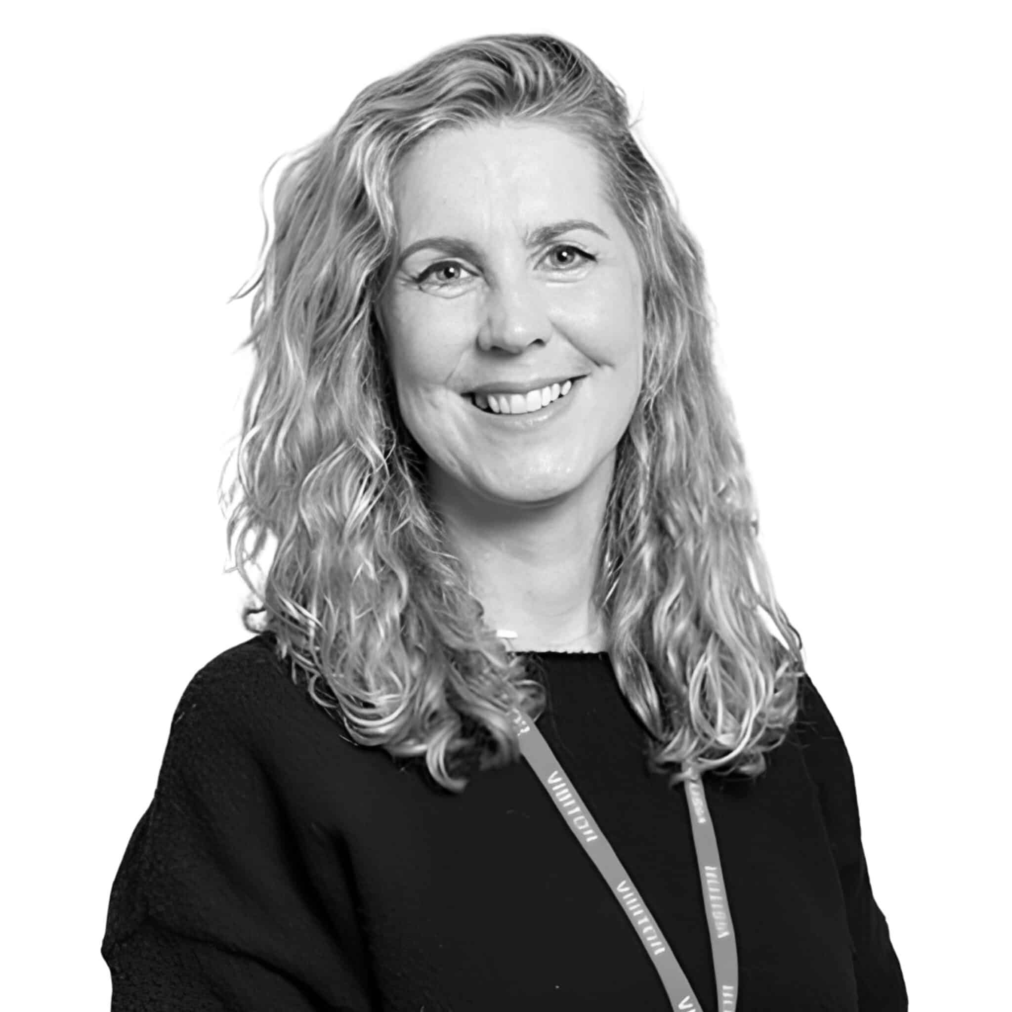 A black and white headshot photograph of Claire Cocks