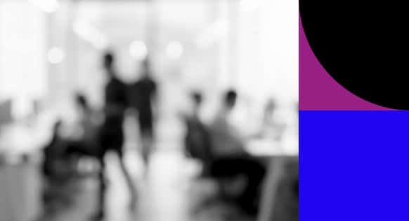 Blurred People in an Open Plan Office at Desks with Purple and Blue Shapes